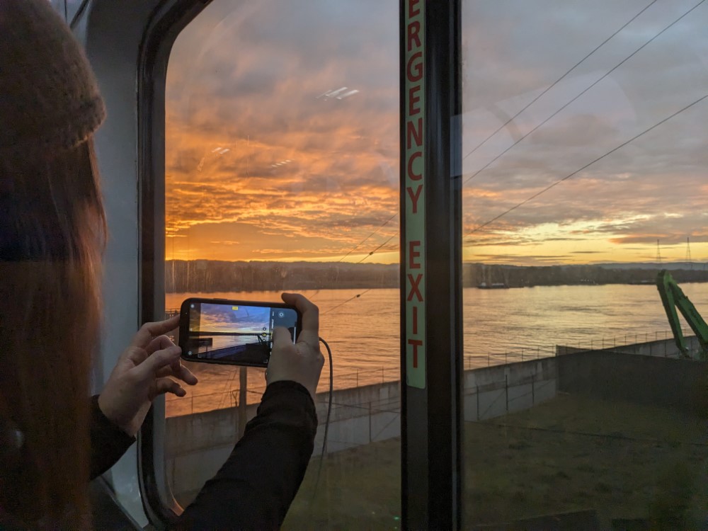 My partner taking a picture of a sunset.