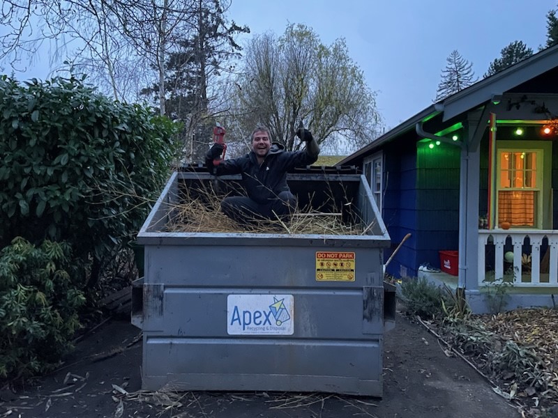 Me in a dumpster full of bamboo, giving a thumbs up.