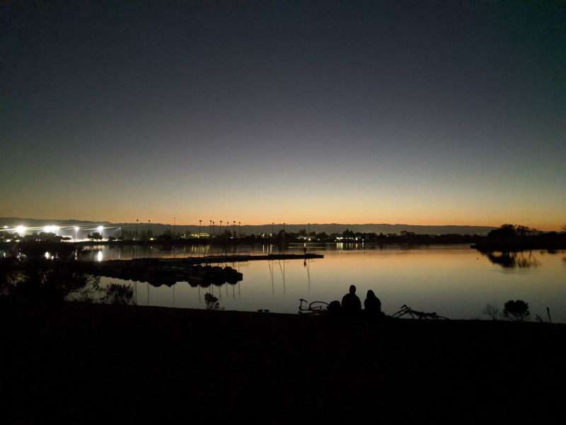 two people sitting by Shoreline Lake