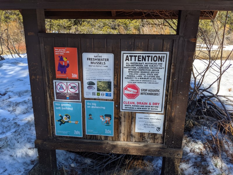 hiking sign with covid warnings