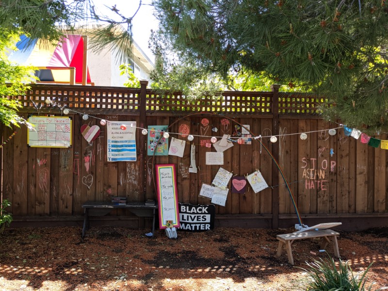 fence with lots of liberal signs